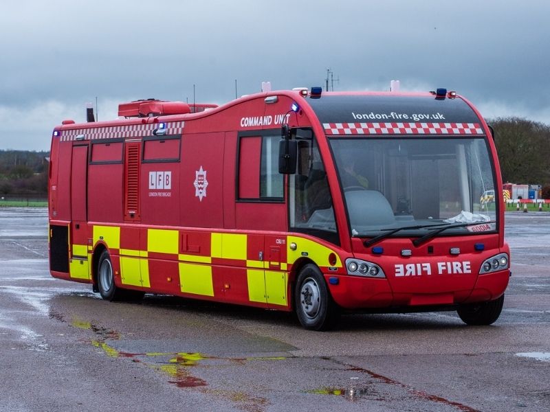 Side view of Command Unit on tarmac under grey skies.