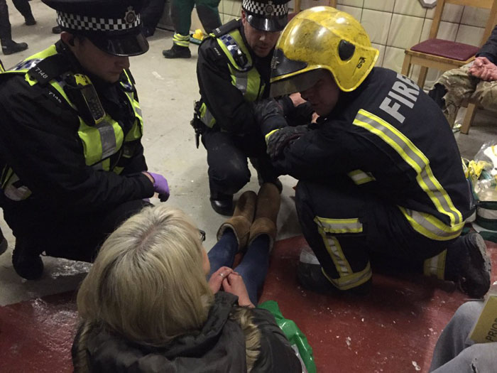 Firefighters and Police Officers attending to a woman