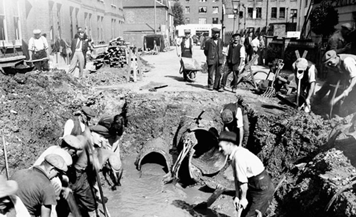 Historical photo of people working on London-water-mains