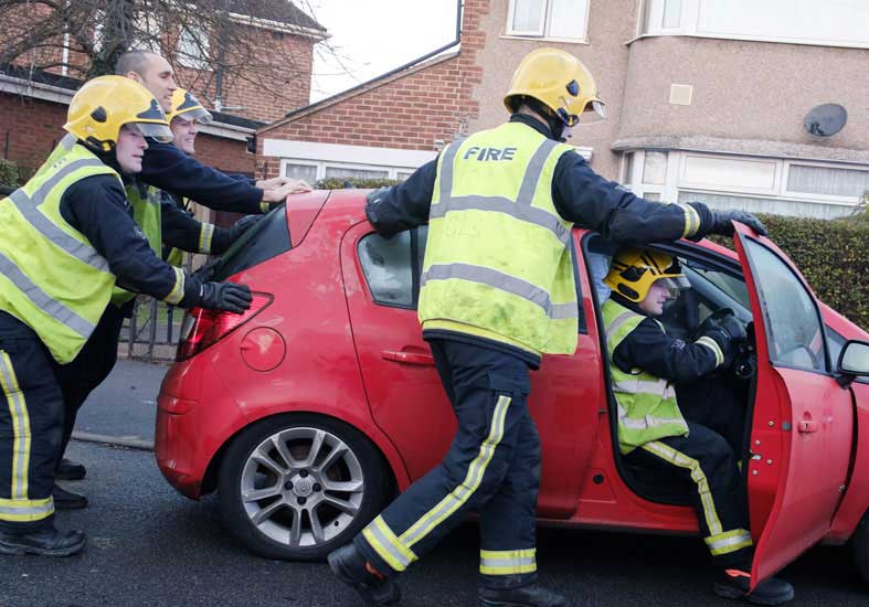 Firefighters attending to a car breakdown  