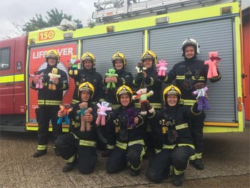 Firefighters from Hillingdon holding up the trauma bears