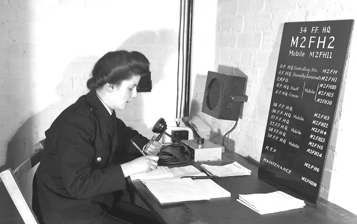 Woman sending radio messages to firefighters during World War 2