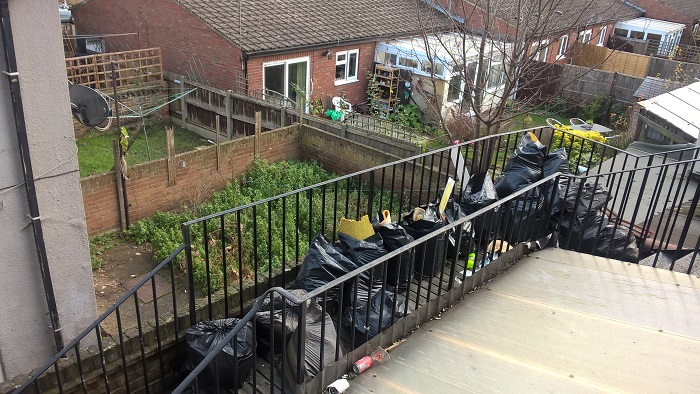 Emergency exit route blocked by rubbish