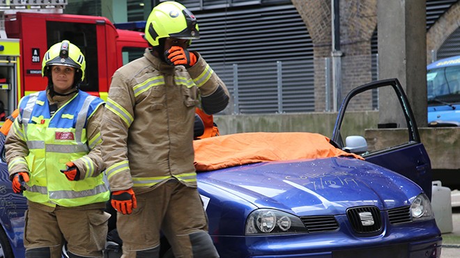 Firefighters attending to a road collision exercise