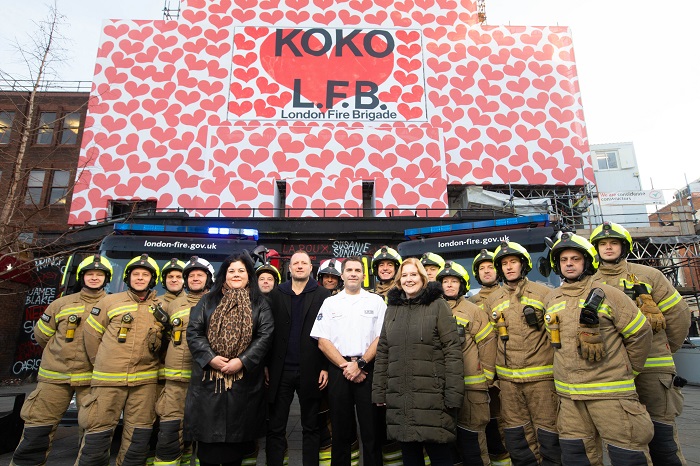 Firefighters outside KOKO nightclub displaying large banner