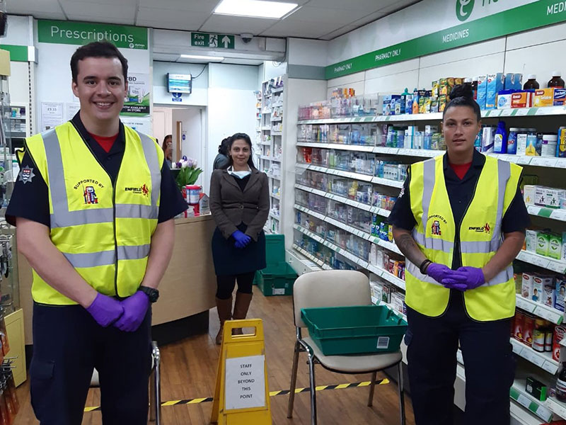 Firefighters in a pharmacy helping out with medication deliveries.