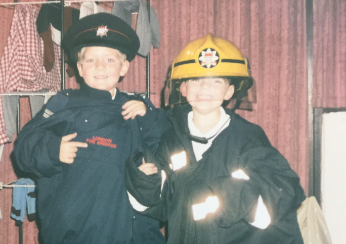 Tom (L) and Jack (R) as children wearing firefighters uniform