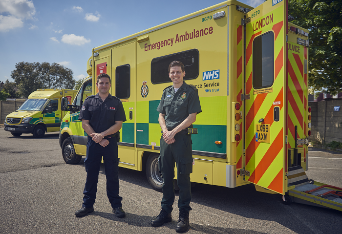 Tom (L) and Jack (R) Binder standing in front of ambulance