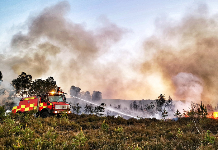 Crews from Surrey Fire and Rescue Services tackle a wildfire on Thursley Common