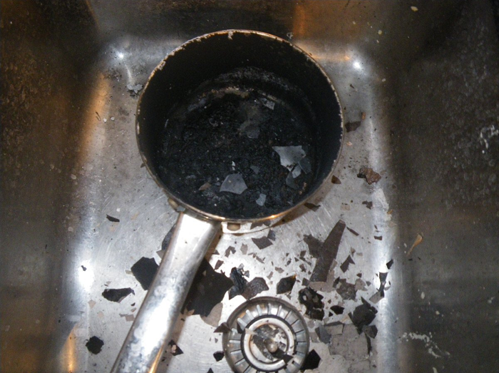 Burnt pan in stainless steel sink