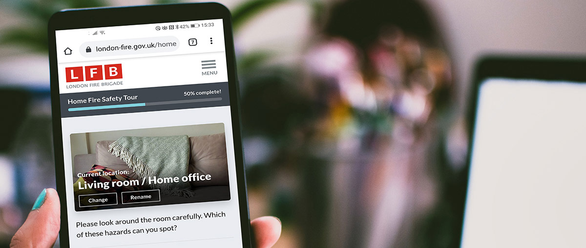 Person using the Home Fire Safety Checker on their smartphone.