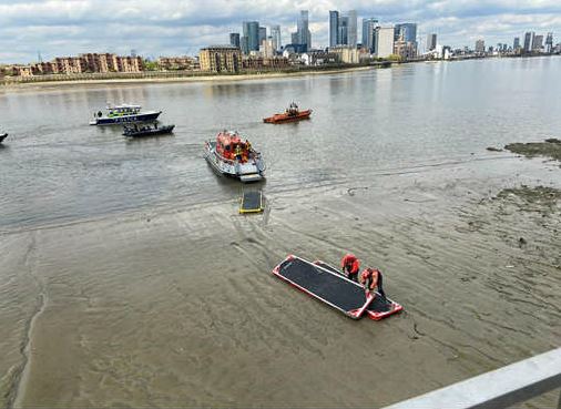 Fire boat crews using mud paths to rescue two women