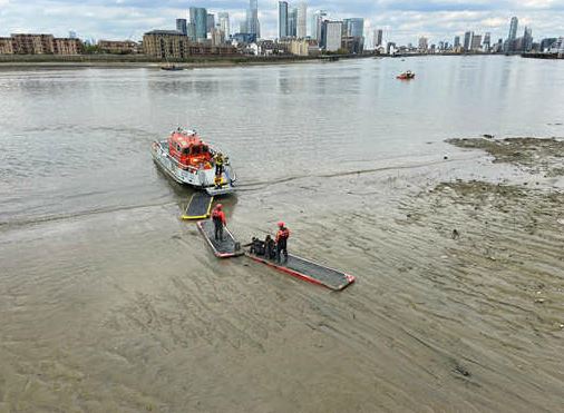 Fire boat crews using mud paths to rescue two women