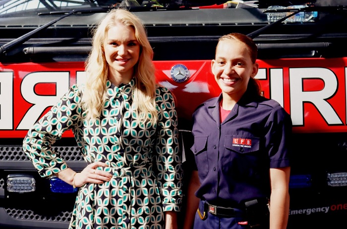 Abbie Quinnen and Firefighter Tiarna-Ann Pearce in front of a fire engine