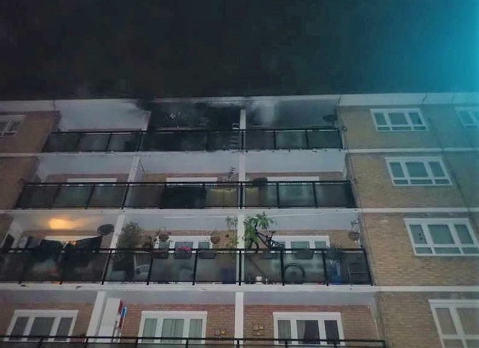 A burnt balcony at the top of a block of flats.