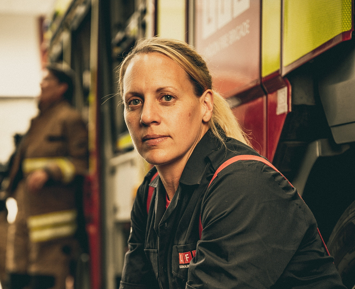 Bex Rowe sitting in front of a fire engine