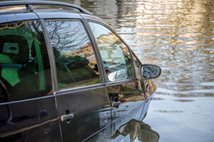 A car half submerged in floodwater