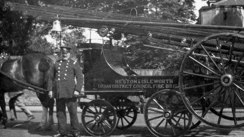 A horse drawn escape cart and a fire officer from Heston and Isleworth Urban District Council Fire Brigade, around 1910.