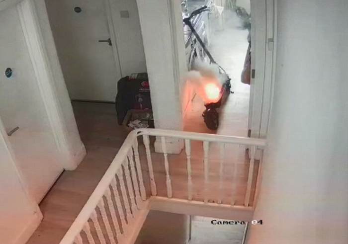 CCTV capture of e-scooter in the doorway on fire