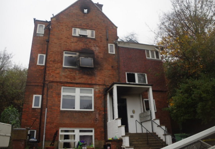 Outside of a block of flats. The area outside the window has been damaged by fire