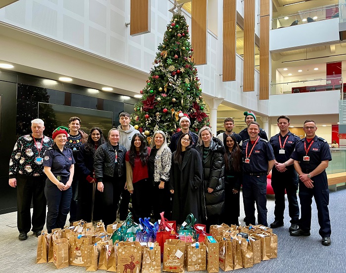 Firefighters and FRS staff pose with presents donated from ThirdEye