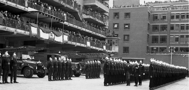 King George reviewing fire service personnel during the opening event