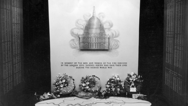 a memorial tablet, featuring St. Paul's Cathedral surrounded in flames. It has "In memory of the men and women of the fire services of the London civil defence region who gave their lives during the second world war"