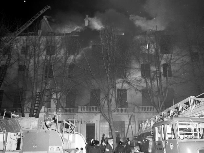 Exterior view of the Worsley Hotel in 1974 during a fire in the building which is causing dark smoke. London Fire Brigade crews are attending the scene.