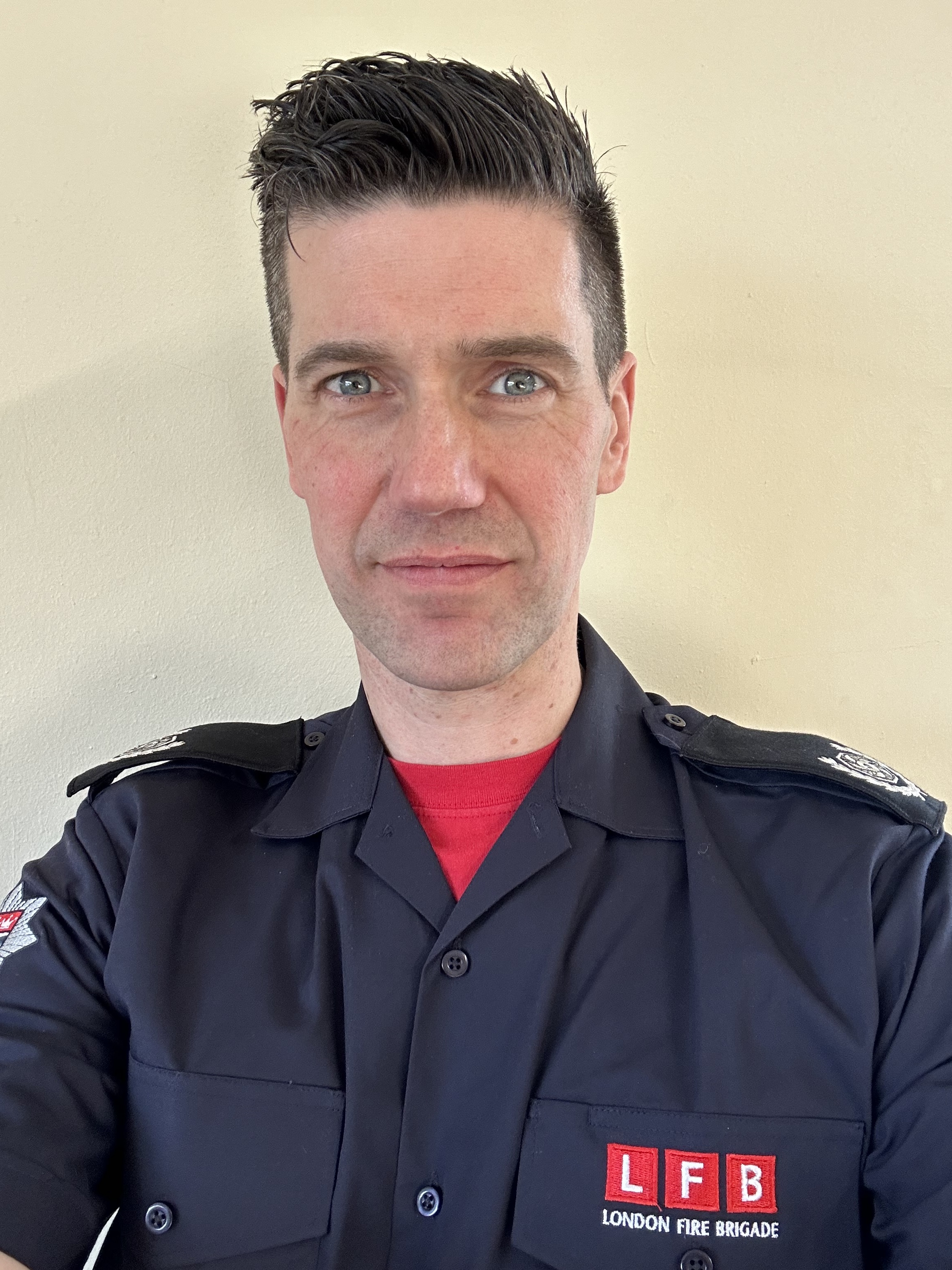 James Ryan wears LFB uniform, he stares directly at the camera with a neutral background